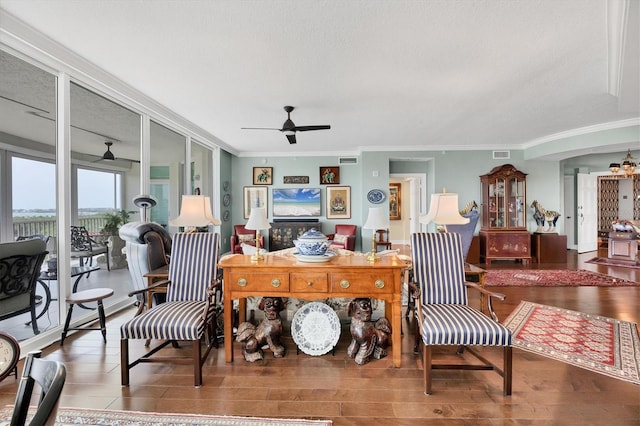 401 N Point Rd Unit 504, Osprey, FL 34229 - living area with a ceiling fan, crown molding, wood finished floors, and a textured ceiling