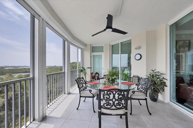 401 N Point Rd Unit 504, Osprey, FL 34229 - sunroom with a ceiling fan, a textured ceiling, tile patterned floors, and outdoor dining area