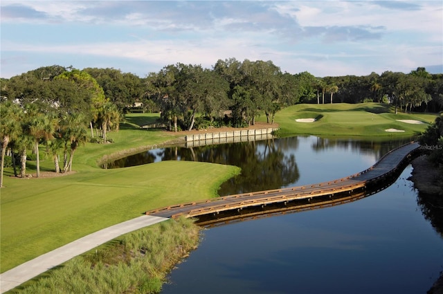 401 N Point Rd Unit 504, Osprey, FL 34229 - view of home's community with view of wooded area, a water view, view of golf course, and a lawn