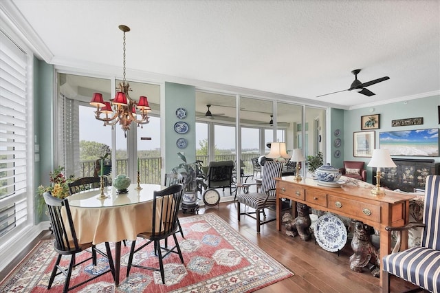 401 N Point Rd Unit 504, Osprey, FL 34229 - dining area with ceiling fan, ornamental molding, wood finished floors, a textured ceiling, and a chandelier