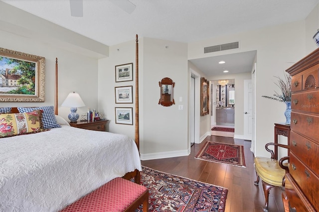 401 N Point Rd Unit 504, Osprey, FL 34229 - bedroom featuring dark wood finished floors, baseboards, ceiling fan, and connected bathroom