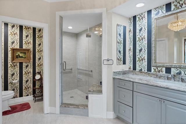 401 N Point Rd Unit 504, Osprey, FL 34229 - bathroom with vanity, a stall shower, toilet, baseboards, and wallpapered walls