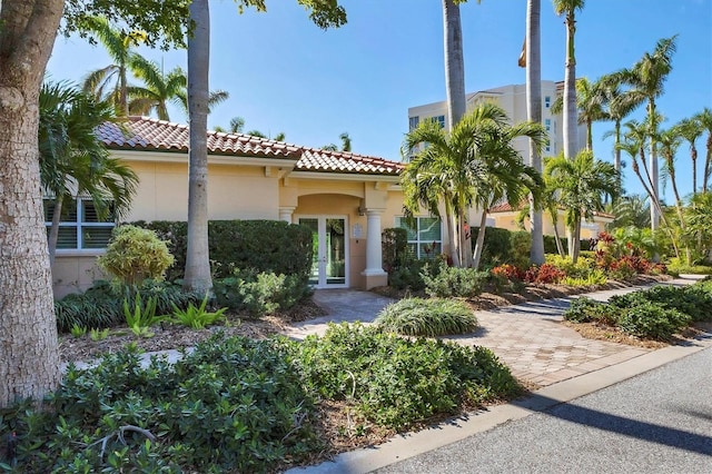 401 N Point Rd Unit 504, Osprey, FL 34229 - mediterranean / spanish-style home featuring a tiled roof, french doors, and stucco siding