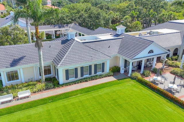 401 N Point Rd Unit 504, Osprey, FL 34229 - back of house featuring a patio area, a yard, and stucco siding
