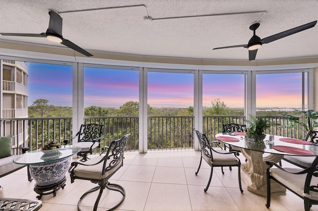 401 N Point Rd Unit 504, Osprey, FL 34229 - sunroom featuring a textured ceiling, tile patterned flooring, and plenty of natural light