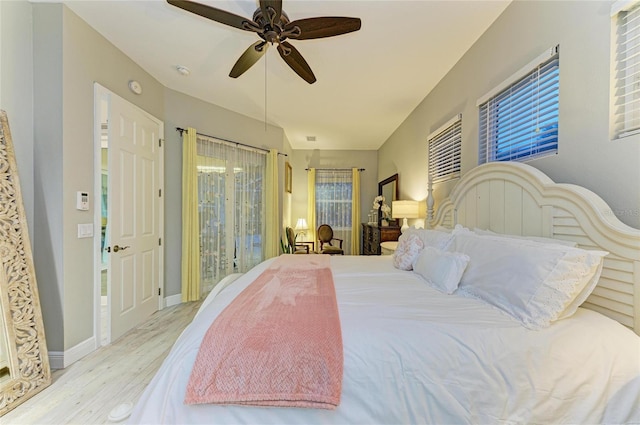 12175 Maple Ridge Dr, Parrish, FL 34219 - bedroom with wood finished floors, ceiling fan, and multiple windows