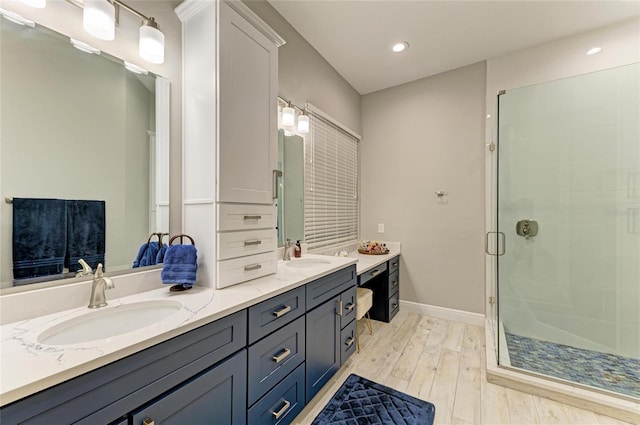 12175 Maple Ridge Dr, Parrish, FL 34219 - bathroom featuring double vanity, a stall shower, wood finished floors, and recessed lighting