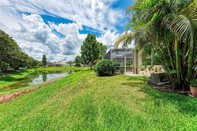 12175 Maple Ridge Dr, Parrish, FL 34219 - view of green lawn with a water view and a lanai