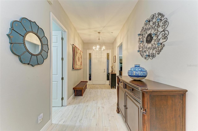 12175 Maple Ridge Dr, Parrish, FL 34219 - hall with a chandelier and light wood finished floors