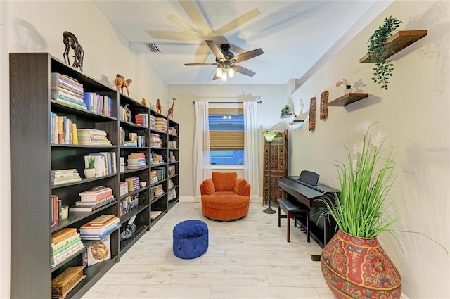 12175 Maple Ridge Dr, Parrish, FL 34219 - sitting room with wood finished floors and a ceiling fan