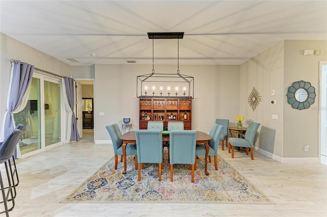 12175 Maple Ridge Dr, Parrish, FL 34219 - dining area with a chandelier and wood finished floors