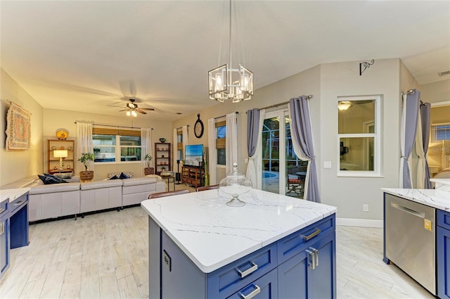 12175 Maple Ridge Dr, Parrish, FL 34219 - kitchen with blue cabinetry, dishwasher, a ceiling fan, open floor plan, and light wood-style flooring