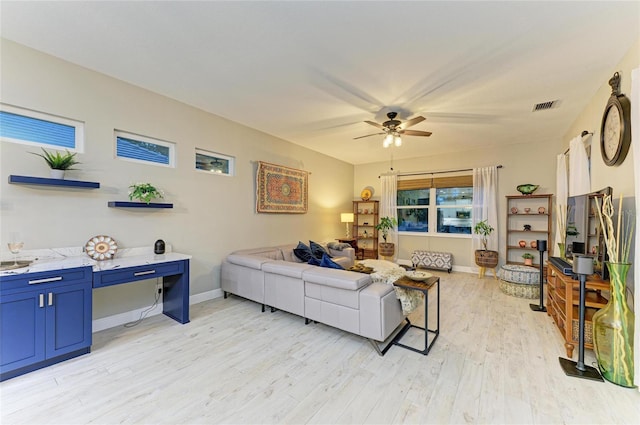 12175 Maple Ridge Dr, Parrish, FL 34219 - living room with a ceiling fan and light wood finished floors