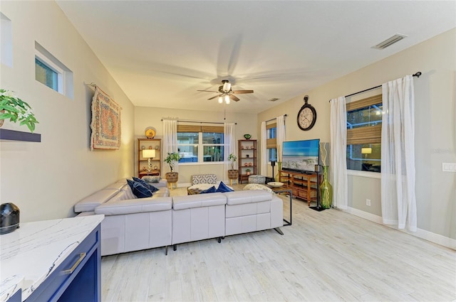 12175 Maple Ridge Dr, Parrish, FL 34219 - living area with ceiling fan and light wood finished floors