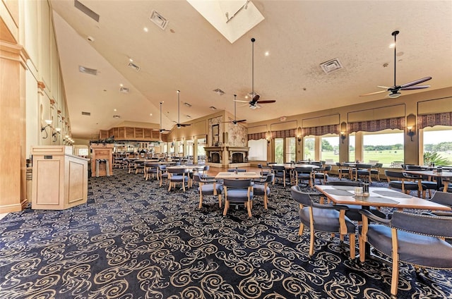 12175 Maple Ridge Dr, Parrish, FL 34219 - dining space with a ceiling fan, high vaulted ceiling, carpet flooring, and a skylight
