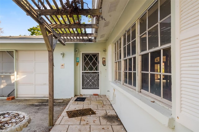 1921 Fairview Dr, Englewood, FL 34223 - doorway to property with a pergola and stucco siding