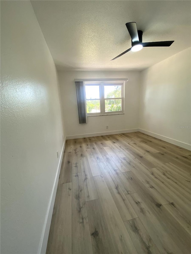 1947 Los Lomas Dr, Clearwater, FL 33763 - spare room featuring baseboards, wood-type flooring, and ceiling fan