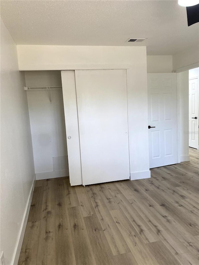 1947 Los Lomas Dr, Clearwater, FL 33763 - unfurnished bedroom with a closet, light wood-type flooring, and baseboards