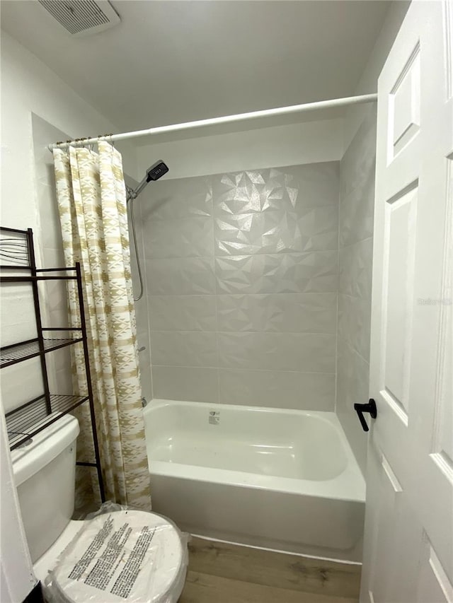 1947 Los Lomas Dr, Clearwater, FL 33763 - full bathroom with toilet, shower / tub combo with curtain, and wood finished floors