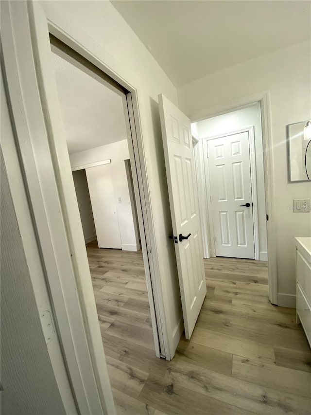 1947 Los Lomas Dr, Clearwater, FL 33763 - hallway featuring light wood-style floors and baseboards