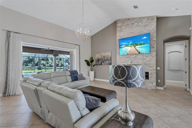 15006 21st Ave E, Bradenton, FL 34212 - living area featuring light tile patterned flooring, a chandelier, vaulted ceiling, and baseboards