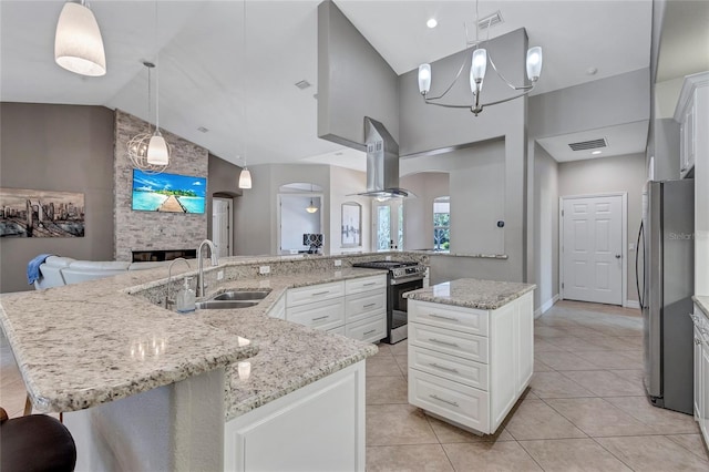 15006 21st Ave E, Bradenton, FL 34212 - kitchen featuring appliances with stainless steel finishes, arched walkways, range hood, a spacious island, and open floor plan