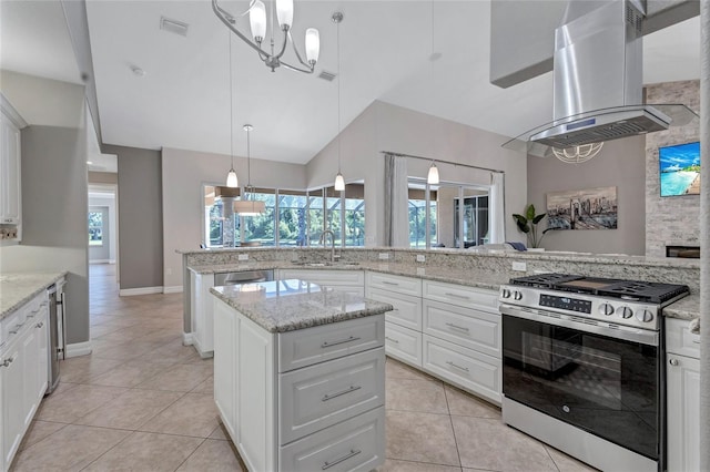 15006 21st Ave E, Bradenton, FL 34212 - kitchen with stainless steel appliances, island exhaust hood, a sink, light tile patterned floors, and a kitchen island