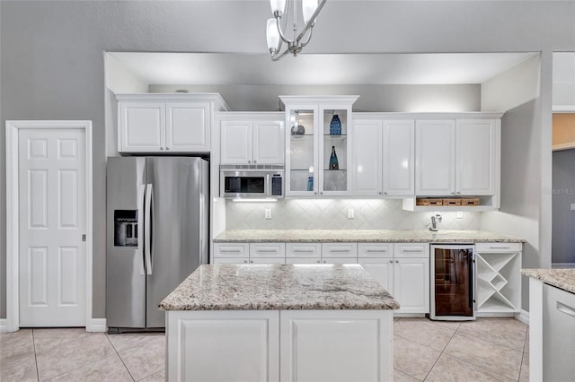 15006 21st Ave E, Bradenton, FL 34212 - kitchen featuring stainless steel appliances, wine cooler, white cabinetry, tasteful backsplash, and light tile patterned flooring