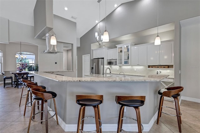 15006 21st Ave E, Bradenton, FL 34212 - kitchen featuring a chandelier, appliances with stainless steel finishes, a high ceiling, a breakfast bar area, and white cabinets