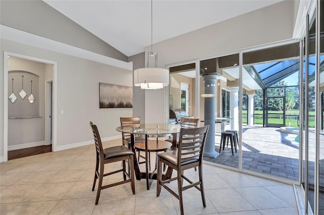 15006 21st Ave E, Bradenton, FL 34212 - dining room featuring vaulted ceiling, light tile patterned floors, and baseboards