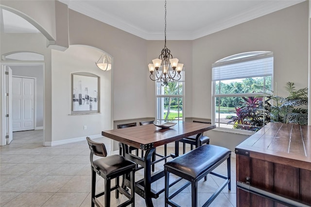 15006 21st Ave E, Bradenton, FL 34212 - dining space with ornamental molding, light tile patterned flooring, a chandelier, arched walkways, and baseboards