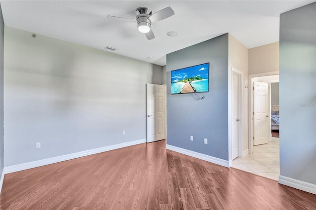 15006 21st Ave E, Bradenton, FL 34212 - unfurnished bedroom with wood finished floors, baseboards, and a ceiling fan