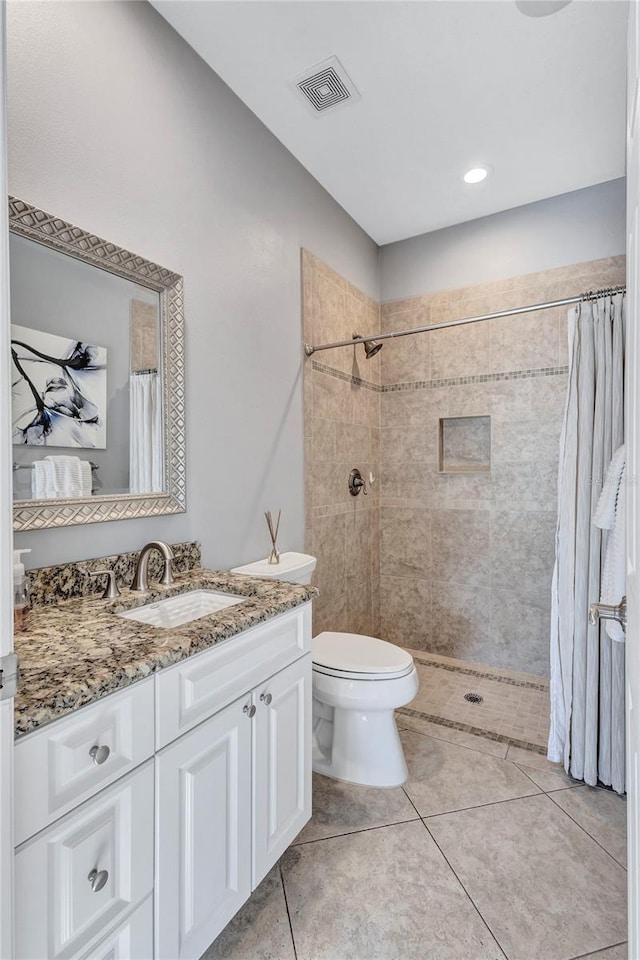 15006 21st Ave E, Bradenton, FL 34212 - bathroom featuring vanity, toilet, tiled shower, and tile patterned flooring
