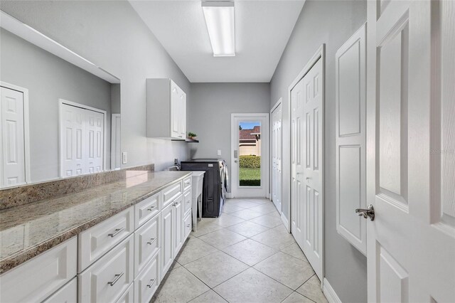 15006 21st Ave E, Bradenton, FL 34212 - laundry room featuring cabinet space, washer and dryer, light tile patterned floors, and baseboards