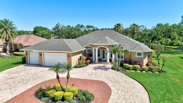 15006 21st Ave E, Bradenton, FL 34212 - single story home with curved driveway, a garage, a front yard, and stucco siding
