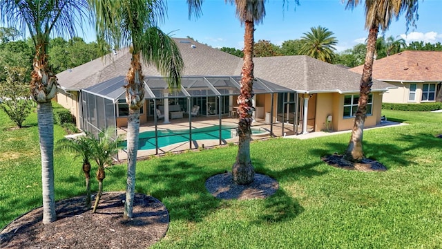 15006 21st Ave E, Bradenton, FL 34212 - rear view of house with a shingled roof, a yard, stucco siding, an outdoor pool, and a patio