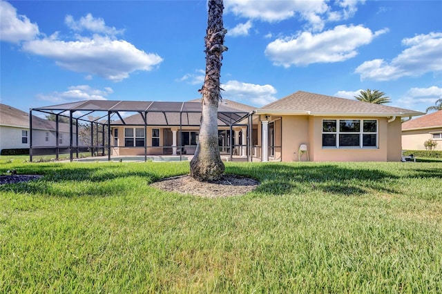 15006 21st Ave E, Bradenton, FL 34212 - rear view of house with stucco siding, a lawn, and glass enclosure
