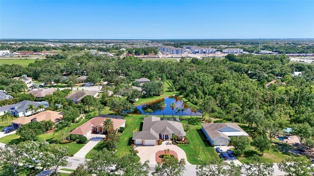 15006 21st Ave E, Bradenton, FL 34212 - aerial overview of property's location featuring a nearby body of water and a tree filled landscape
