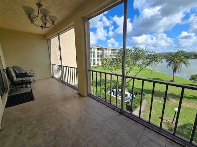 3917 Lake Bayshore Dr Unit F-307, Bradenton, FL 34205 - unfurnished sunroom with a water view and a chandelier