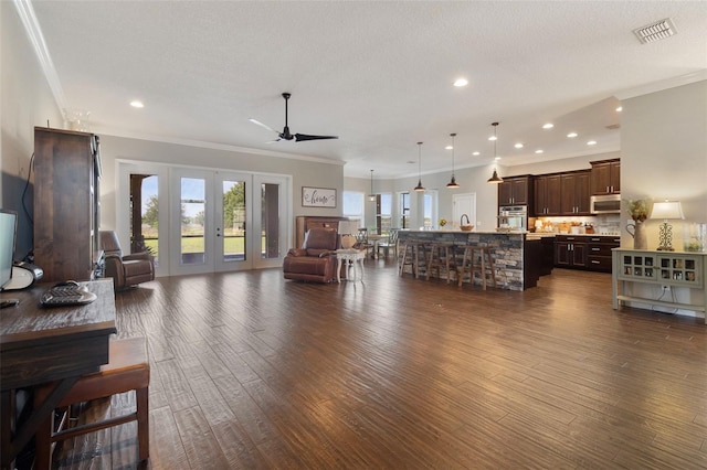 2350 Virgil Hall Rd, Lithia, FL 33547 - living area with ornamental molding, dark wood-style flooring, ceiling fan, recessed lighting, and french doors