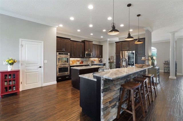 2350 Virgil Hall Rd, Lithia, FL 33547 - kitchen with a spacious island, appliances with stainless steel finishes, a breakfast bar, crown molding, and recessed lighting