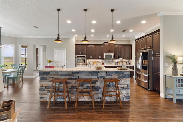 2350 Virgil Hall Rd, Lithia, FL 33547 - kitchen featuring appliances with stainless steel finishes, dark brown cabinets, crown molding, a breakfast bar, and recessed lighting