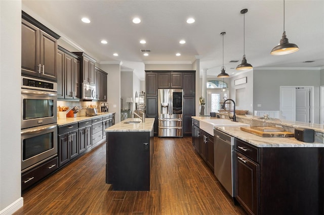 2350 Virgil Hall Rd, Lithia, FL 33547 - kitchen with a large island, appliances with stainless steel finishes, a sink, ornamental molding, and dark brown cabinets
