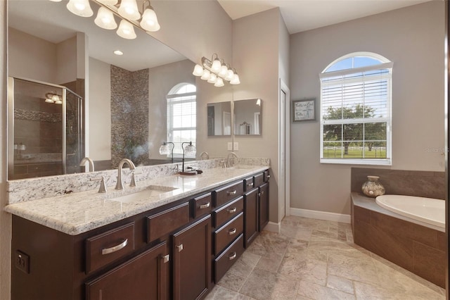 2350 Virgil Hall Rd, Lithia, FL 33547 - full bath with double vanity, a bath, a shower stall, baseboards, and a chandelier
