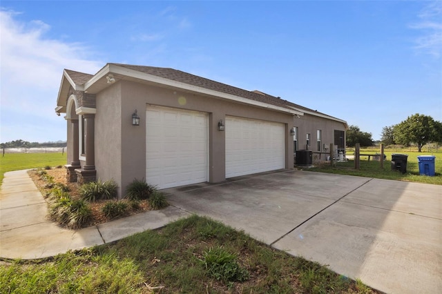 2350 Virgil Hall Rd, Lithia, FL 33547 - view of side of property with stucco siding, concrete driveway, an attached garage, and a shingled roof