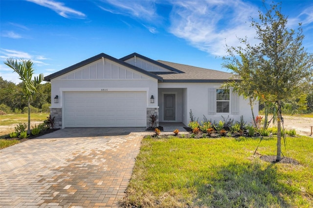 5213 Patano Loop, Palmetto, FL 34221 - single story home with decorative driveway, an attached garage, a front lawn, stone siding, and board and batten siding