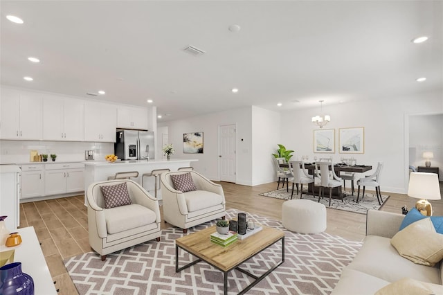 5213 Patano Loop, Palmetto, FL 34221 - living room featuring light wood-type flooring, a chandelier, and recessed lighting