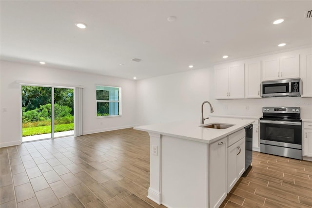 5213 Patano Loop, Palmetto, FL 34221 - kitchen featuring stainless steel appliances, a sink, open floor plan, light countertops, and recessed lighting