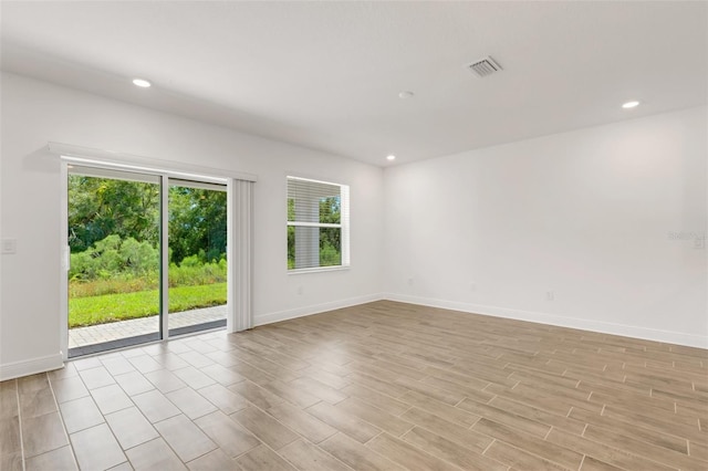 5213 Patano Loop, Palmetto, FL 34221 - empty room with plenty of natural light, baseboards, light wood-type flooring, and recessed lighting