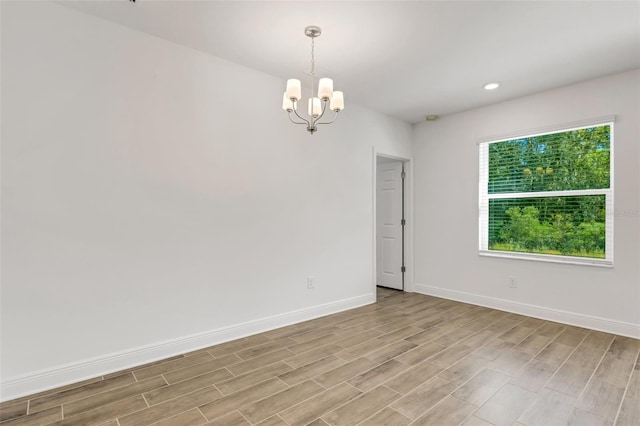 5213 Patano Loop, Palmetto, FL 34221 - unfurnished room with a chandelier, light wood-style floors, baseboards, and recessed lighting
